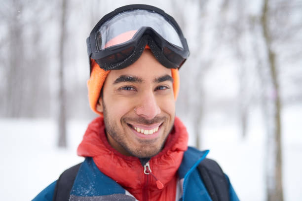 istock Smiling diverse couple holding Christmas presents while walking through a winter forest 1179065929