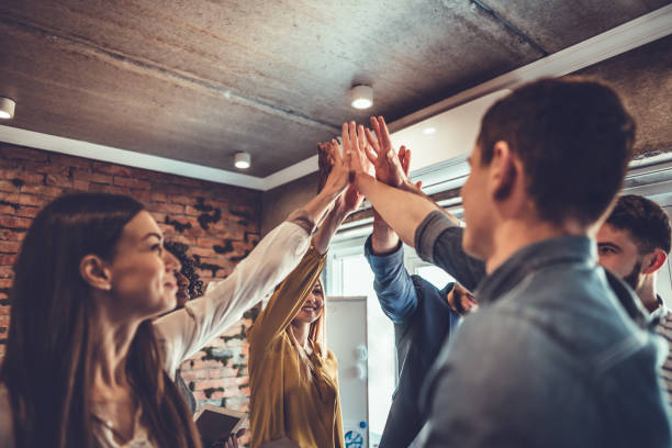 istock happy business team giving high five in office 1179066008