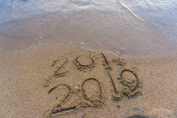istock 2019 Number on sea beach wave Happy new year concept background 1179068931