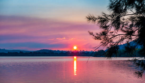 istock A calm lake displaying late afternoon colors 1179071618