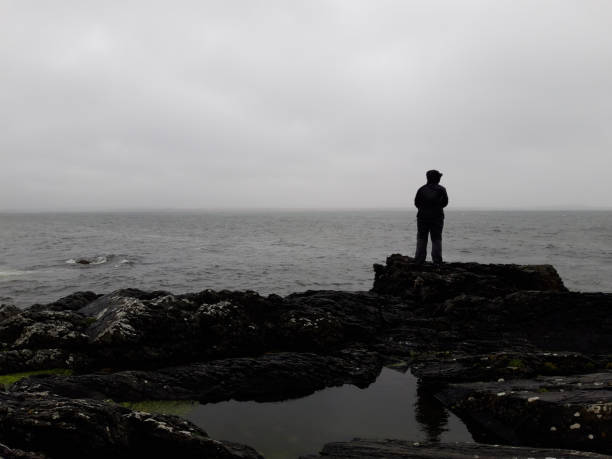 istock Lone figure stormy sea 1179076835