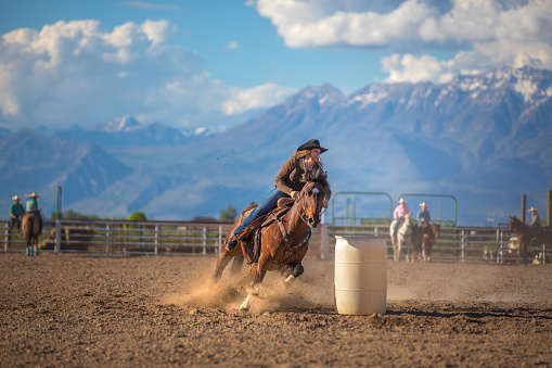Cowgirl barrel racing at a local rodeo arena