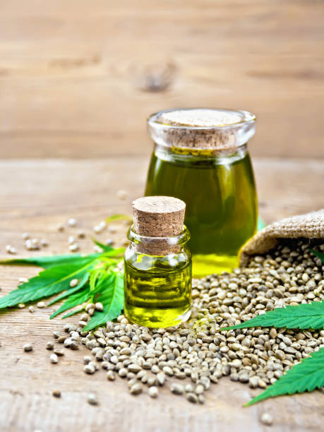 istock Oil hemp in two jars with grain on old board 1179102229