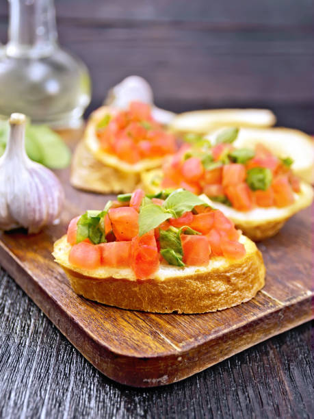 istock Bruschetta with tomato and spinach on dark board 1179102875