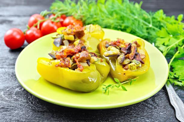 istock Pepper stuffed with vegetables in green plate on black board 1179103040
