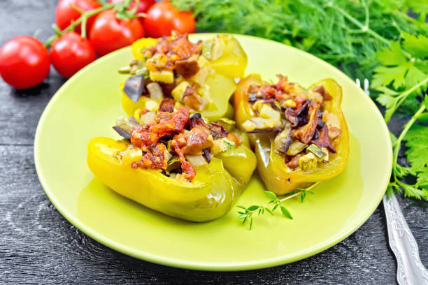 istock Pepper stuffed with vegetables in green plate on board 1179103042