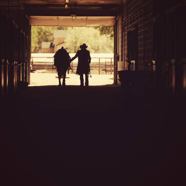 istock Cowboy at a horse stable 1179103177