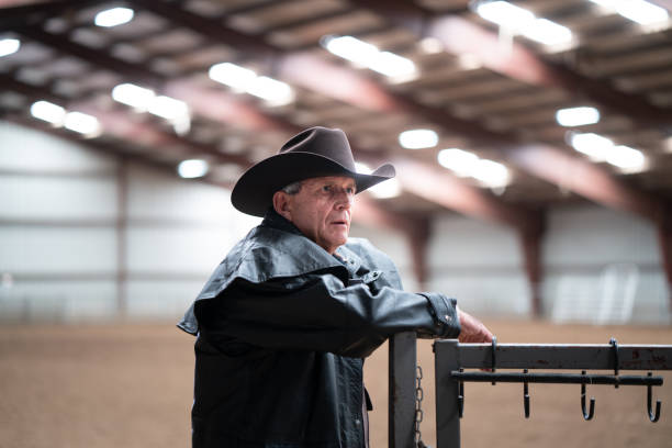 istock Cowboy at a horse stable 1179103190