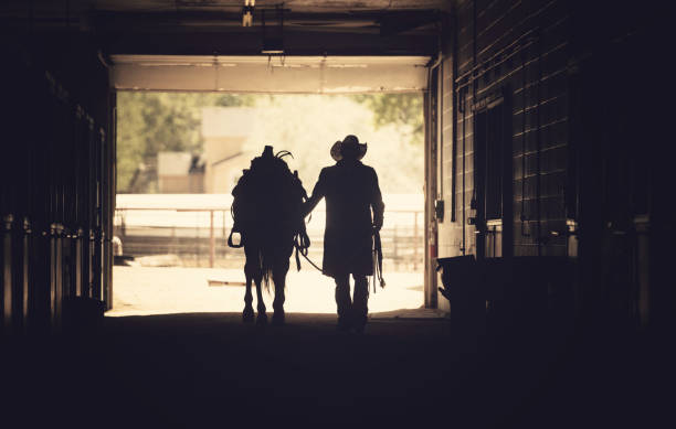 istock Cowboy at a horse stable 1179103721