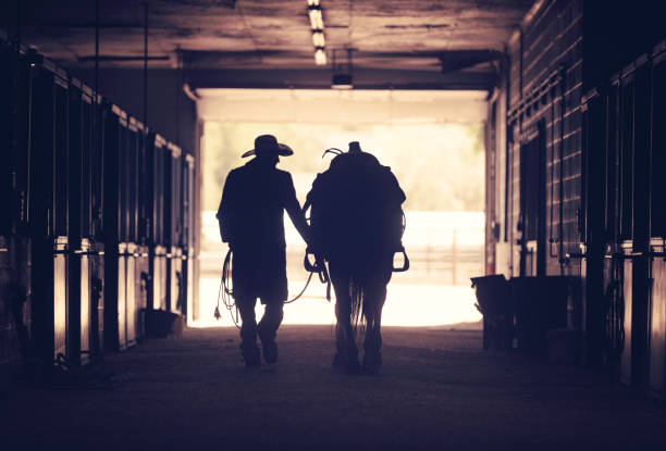 istock Cowboy at a horse stable 1179103728
