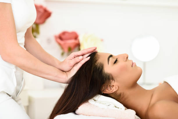 istock Woman receiving head massage in spa wellness center. 1179104792
