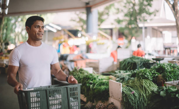 istock an asian malay vegetable owner arranging vegetables at his stall getting ready for the day 1179104894
