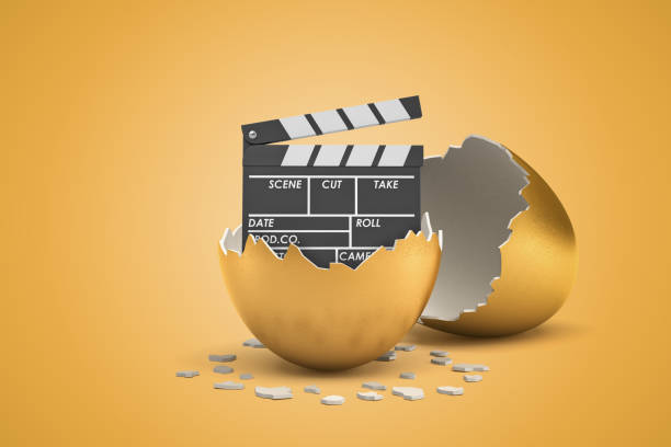 istock 3d rendering of broken golden eggshell with movie clapper inside on yellow background 1179109863