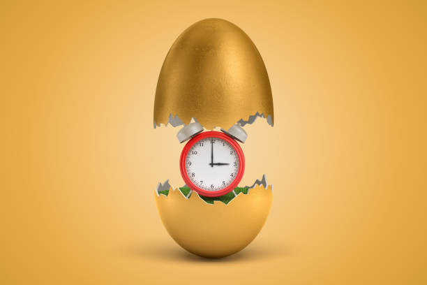 istock 3d rendering of red alarm clock hatching out of golden egg on yellow background 1179110715