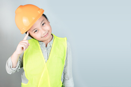 Little boy in engineering uniform with helmet and copy space