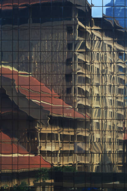 istock juxtaposition, modern building curtain wall reflecting retro traditional style building 1179115326