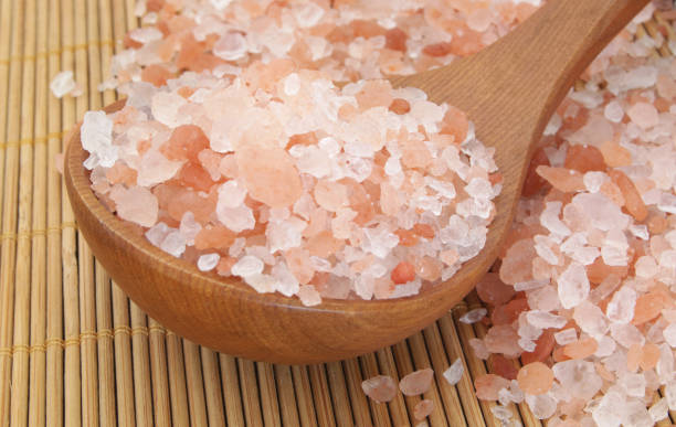 istock Pink himalayan rock salt on bamboo background 1179115895
