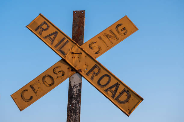 Old and Worn Yellow Railroad Crossing Sign in Victoria Falls, Zimbabwe