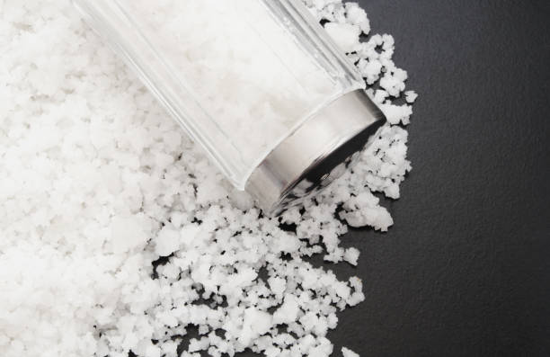 istock Salt and salt shaker on black 1179116414