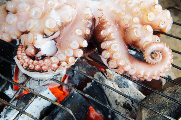 istock Seafood barbecue, octopus cooking on grill 1179118468
