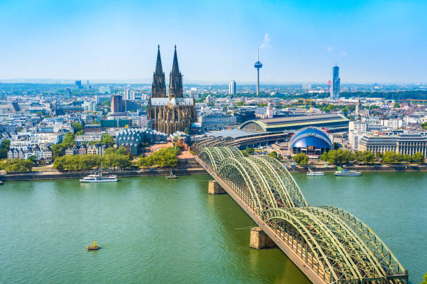 Beautiful panoramic aerial landscape of the gothic catholic Cologne cathedral, Hohenzollern Bridge and the River Rhine in Cologne, Germany Cologne, North Rhine Westphalia, Germany: Beautiful panoramic aerial landscape of the gothic catholic Cologne cathedral, Hohenzollern Bridge and the River Rhine. railway bridge photos stock pictures, royalty-free photos & images