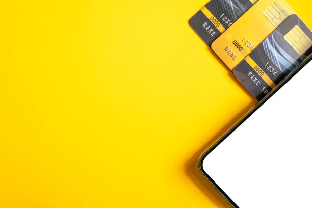 istock Credit cards and smartphone on yellow background. 1179119659