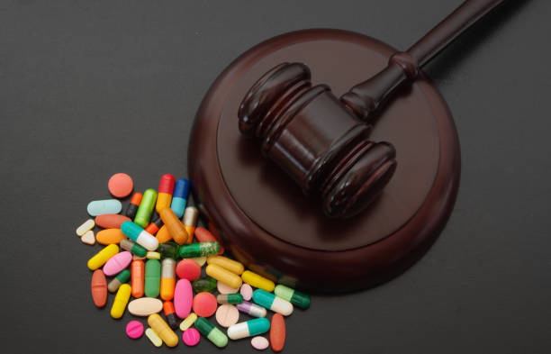 istock Judge gavel with drugs on table 1179120813