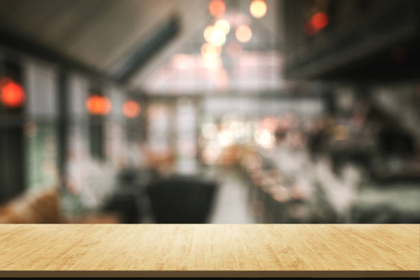 istock Empty wooden table in front with blur background of bar cafe and restaurant. 1179120866