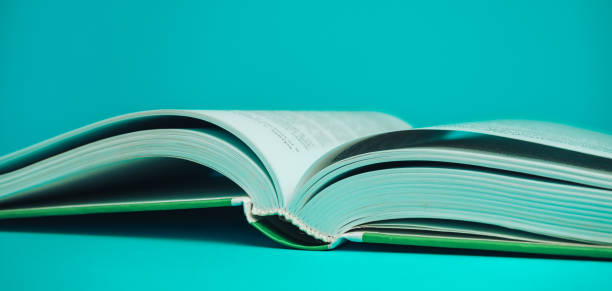 istock Close up open Beautiful new book on a aquamarine background. 1179121588