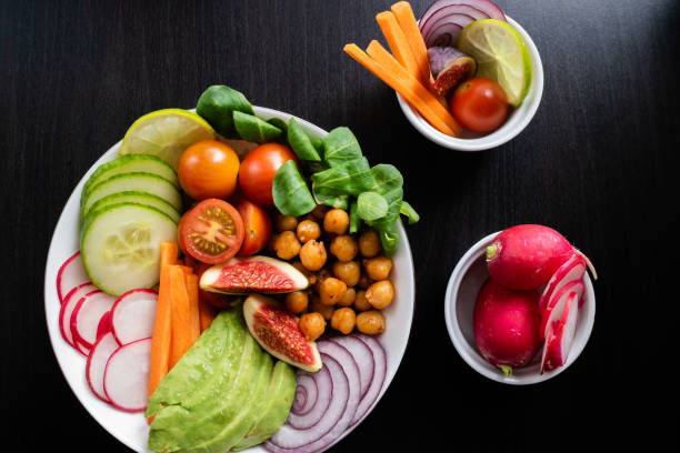 istock Buddha bowl made with organic vegetables and two cups with other ingredients. Top view. 1179122246