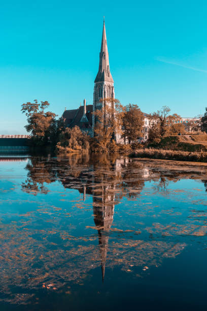 chiesa di sant'alban riflessa nell'acqua nel tardo autunno - medieval autumn cathedral vertical foto e immagini stock