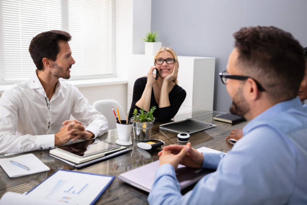 istock Woman Speaking On The Phone While Sitting In A Meeting 1179124078