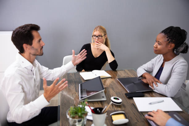 istock Business Man Discussing Project Sitting At Office Desk 1179124095