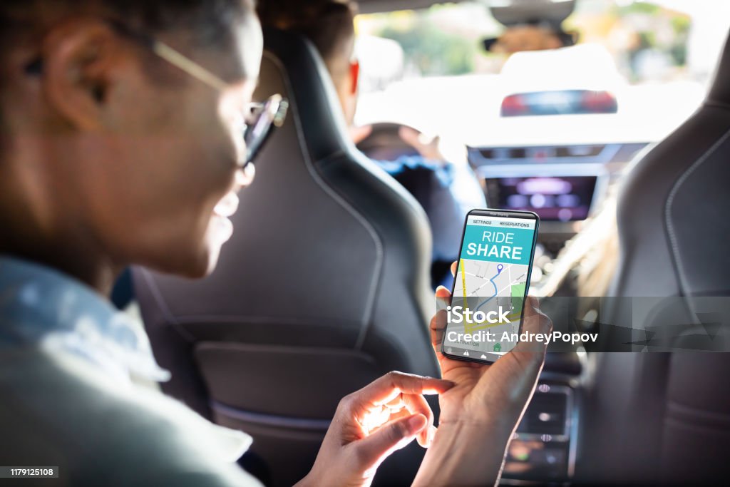 African Woman Using Car Sharing App African Woman Using Car Sharing App While Sitting In Car Car Pooling Stock Photo