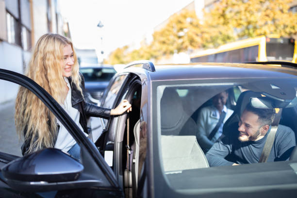 Woman Sitting In Car With Friends Happy Blonde Women Sitting Inside Car With Her Friends car pooling photos stock pictures, royalty-free photos & images