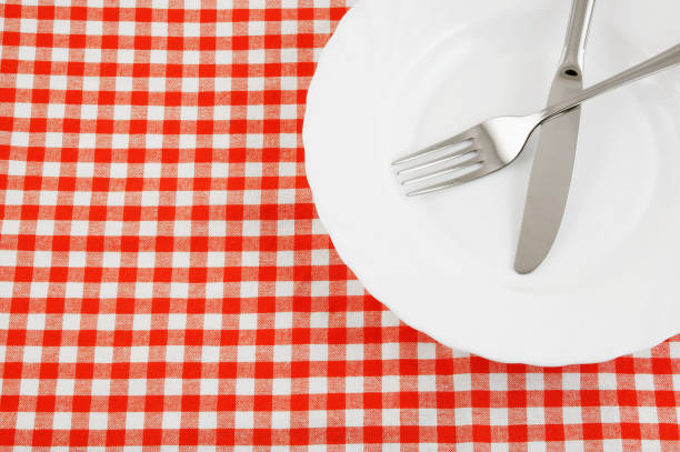 istock Close up of knife and fork in plate on tablecloth 1179125223