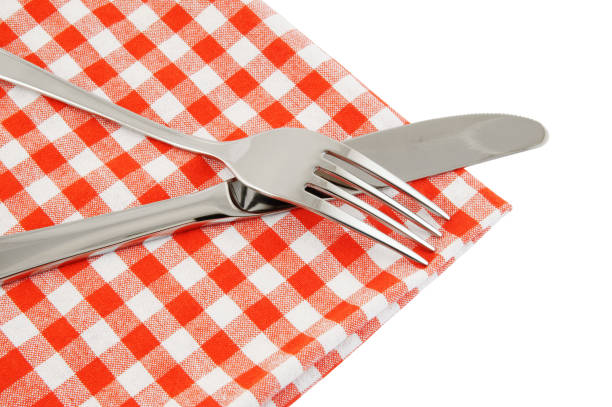 istock Close up of knife and fork with tablecloth isolated 1179125242