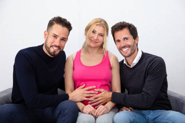 Smiling Men Touching The Belly Of Pregnant Surrogate Woman Portrait Of A Smiling Men Touching The Belly Of Pregnant Surrogate Woman surrogacy stock pictures, royalty-free photos & images