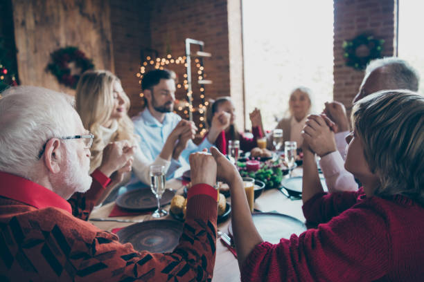 istock Nice friendly harmony idyllic peaceful calm big full family generation spending wintertime gathering tradition eating lunch holding hands praying in modern industrial loft decorated house indoors 1179128998