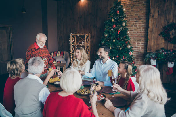 istock Nice lovely friendly idyllic cheerful big full family spending December gathering tradition eating brunch grandpa saying toast in modern industrial loft brick style interior decorated house 1179129613