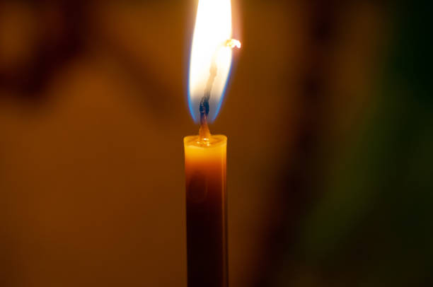 istock One candle flame at night closeup - isolated, macro 1179130213