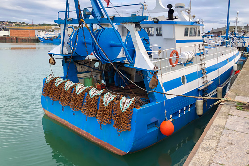 Rusty boat and metal nets for catching scallops