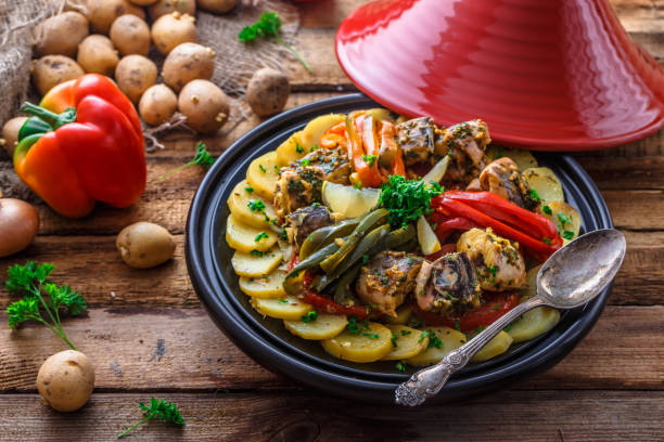 Moroccan fish tagine with chermoula, red peppers and potato stock photo