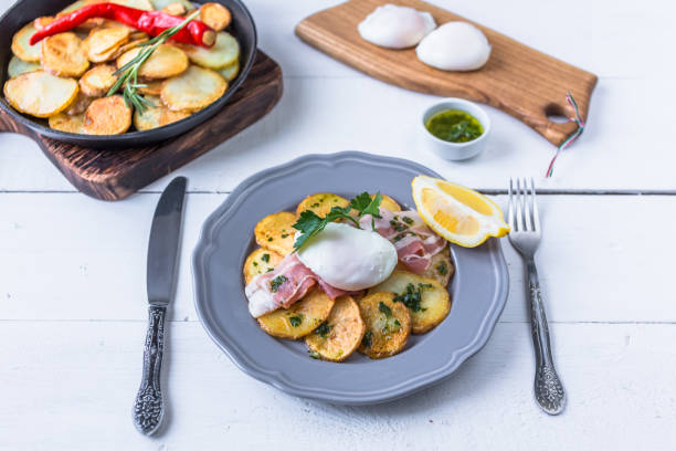istock Spanish tapas huevos rotos. Fried eg, jamon ham and potato 1179130962