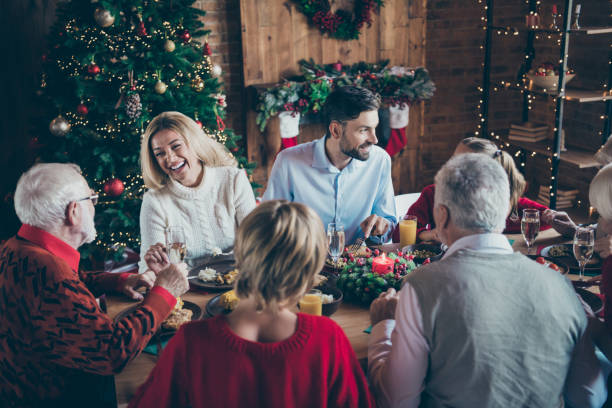 photo of full family gathering sitting dinner table communicating chatting overjoyed x-mas party multi-generation in newyear decorated living room indoors - family christmas imagens e fotografias de stock