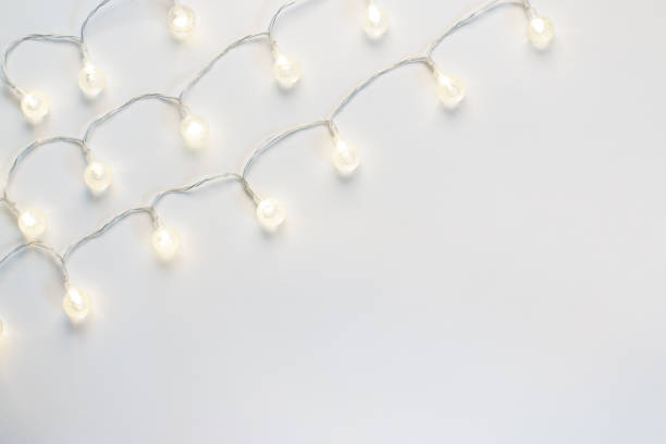 istock Shining christmas lights border with copy space on white background 1179131316