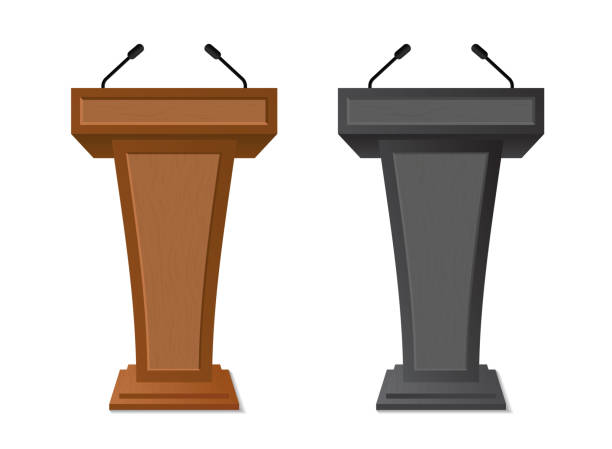 istock Podium rostrum with microphone for debate, speech, press conference, dispute, audience. Podium tribune with empty place for speaker, lecture.Isolated stage stand for debate.vector 1179132210
