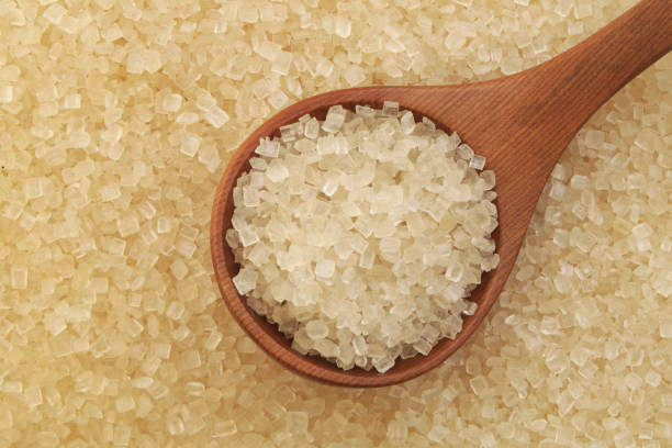 istock Pure brown rock sugar with wooden spoon 1179132212