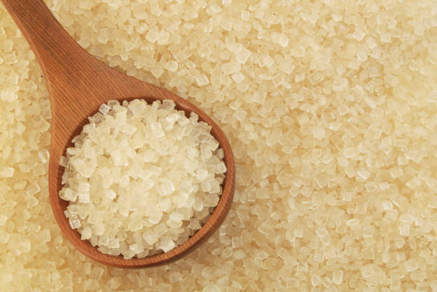 istock Pure brown rock sugar with wooden spoon 1179132232
