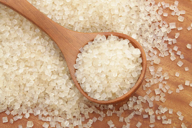 istock Wooden spoon and sugar on wooden table 1179132345
